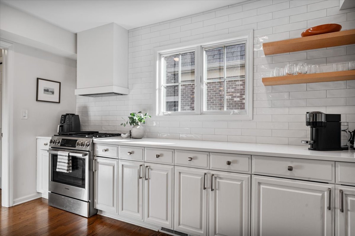 989 Ash Street Winnetka, IL 60093 - Photo 10 of 35 a kitchen with stainless steel appliances white cabinets and a counter top space
