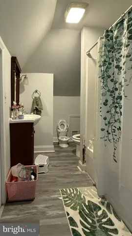 a bathroom with a bathtub shower sink and toilet