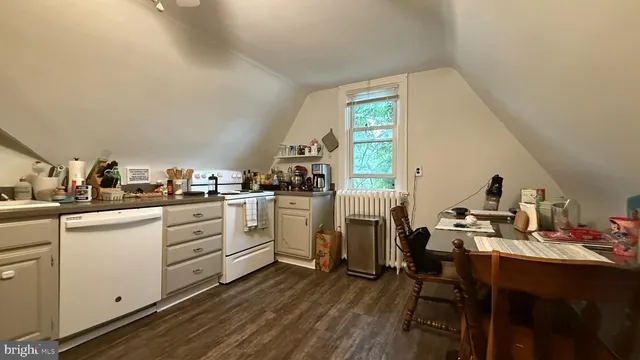 a kitchen with cabinets and wooden floor