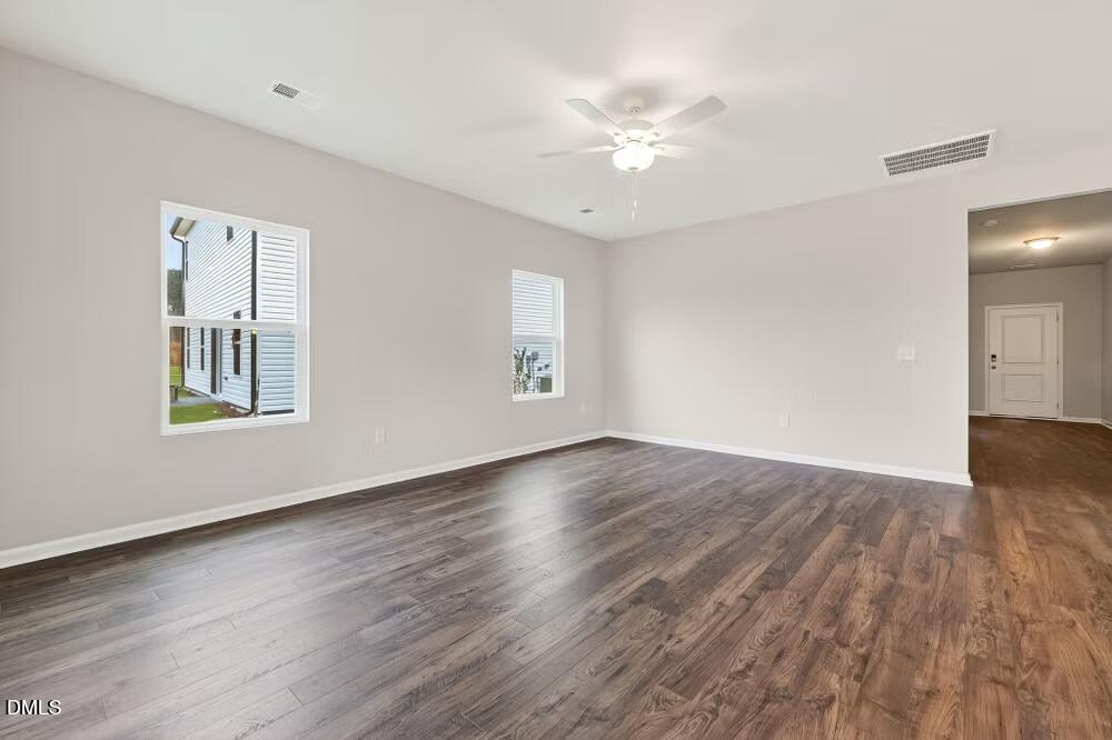 460 Hallingsfield Way Zebulon, NC 27597 - Photo 13 of 31 a view of an empty room with wooden floor and a window
