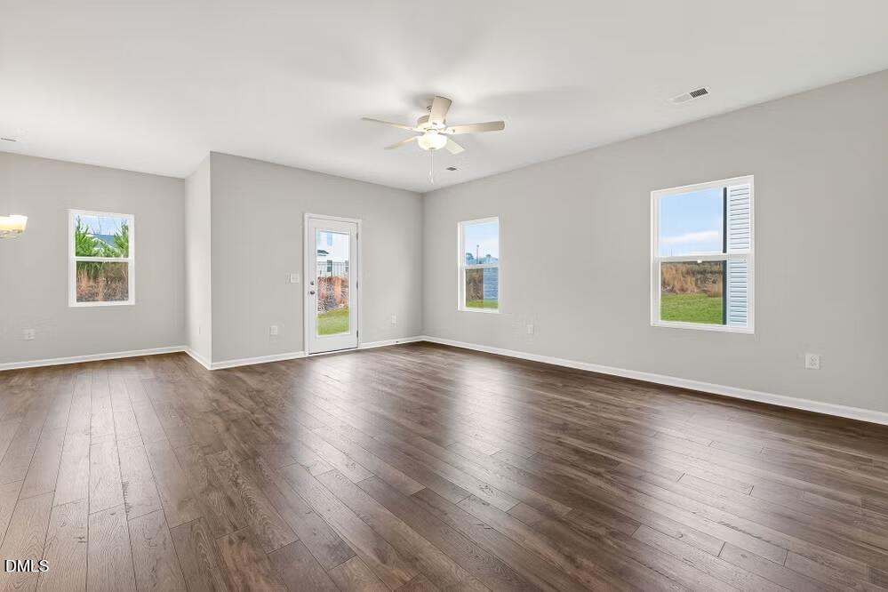 460 Hallingsfield Way Zebulon, NC 27597 - Photo 14 of 31 a view of an empty room with wooden floor and a window
