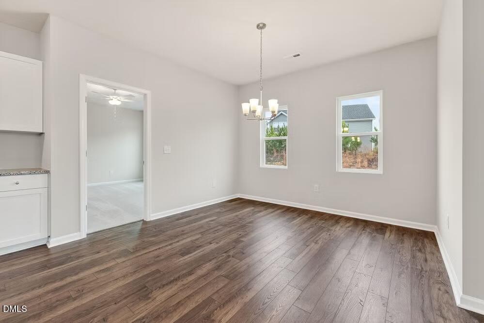 460 Hallingsfield Way Zebulon, NC 27597 - Photo 18 of 31 an empty room with wooden floor and windows