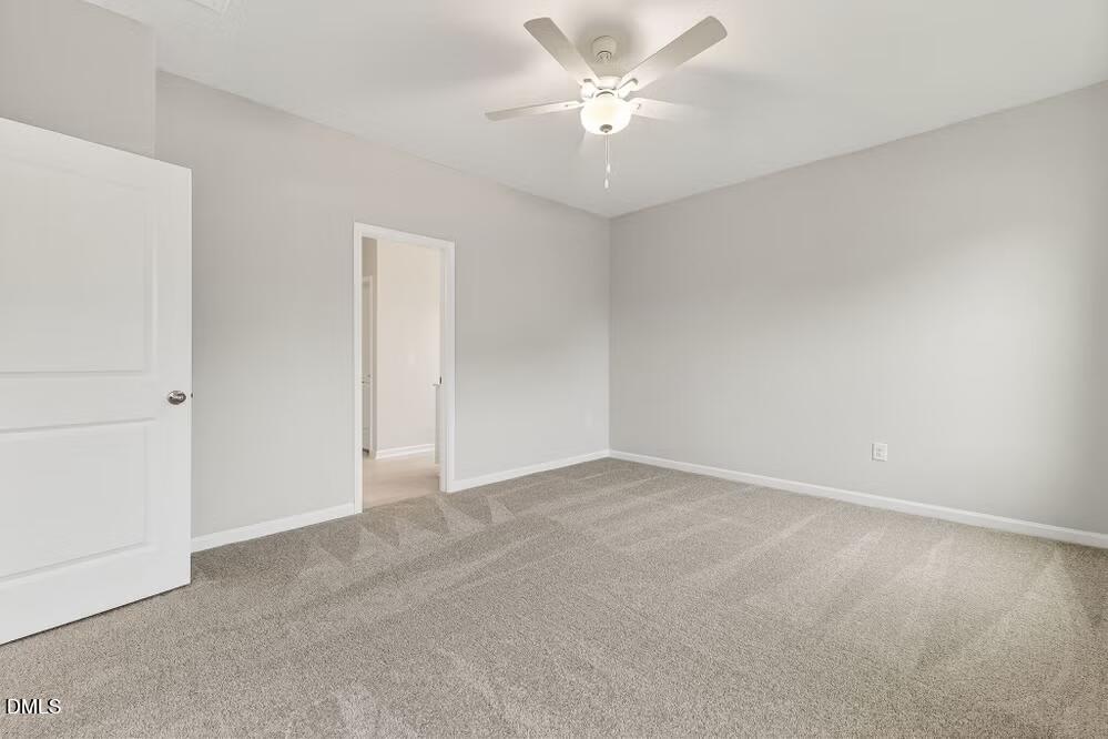 460 Hallingsfield Way Zebulon, NC 27597 - Photo 24 of 31 an empty room with a chandelier fan and windows