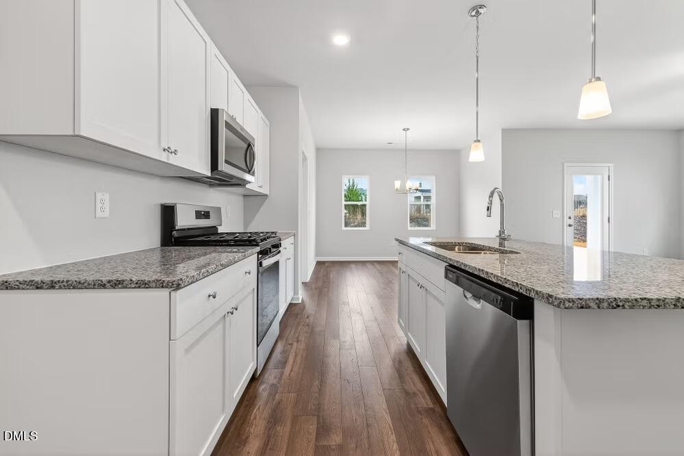 460 Hallingsfield Way Zebulon, NC 27597 - Photo 9 of 31 a large kitchen with granite countertop a large counter top space a sink stainless steel appliances and cabinets