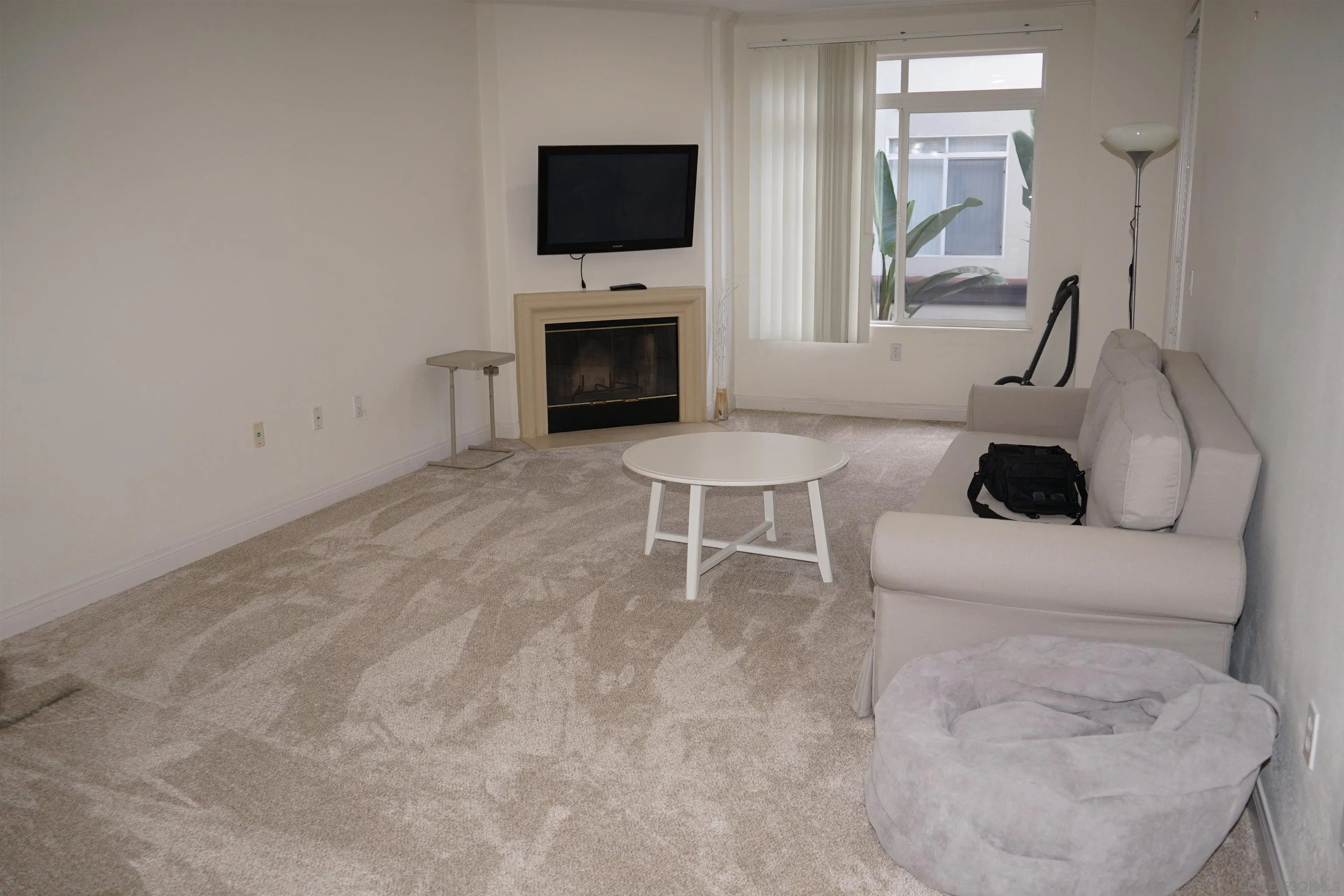 9263 Regents Road San Diego, CA 92037 - Photo 11 of 14 a living room with furniture a fireplace and a flat screen tv