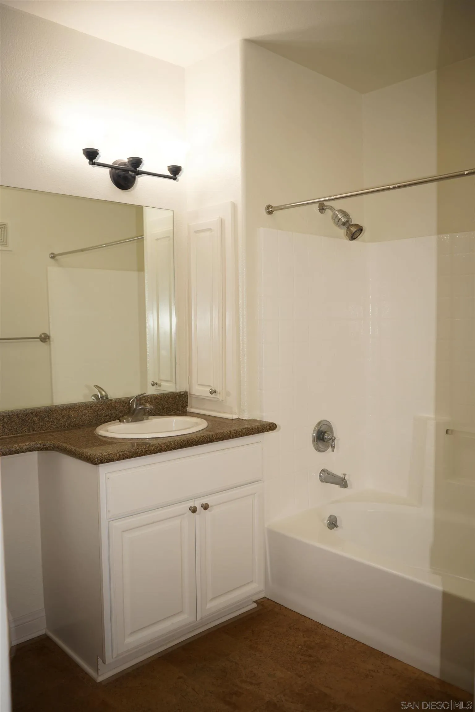 9263 Regents Road San Diego, CA 92037 - Photo 13 of 14 a bathroom with a granite countertop sink a toilet and shower