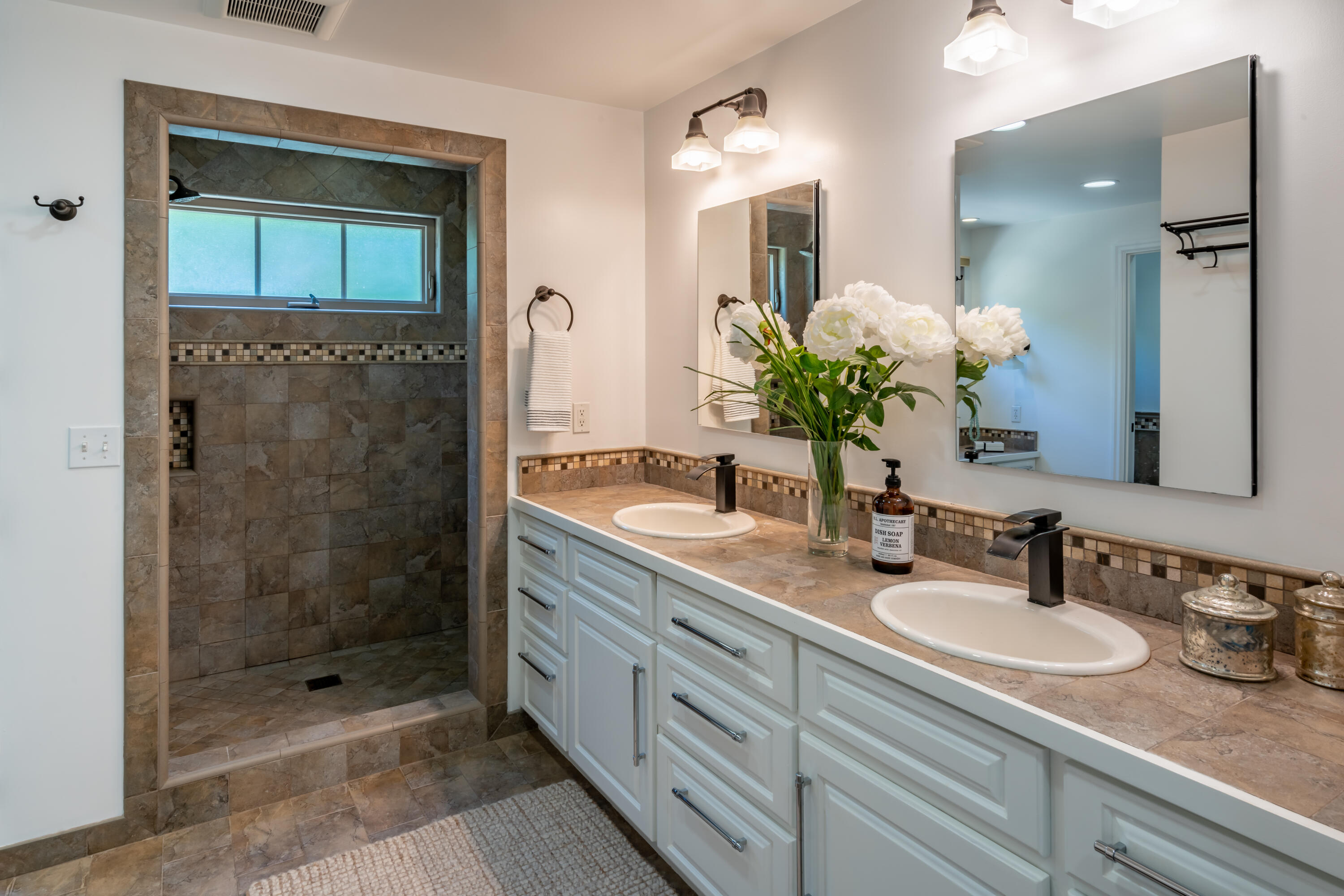 1180 High Road Montecito, CA 93108 - Photo 13 of 39 a bathroom with a granite countertop sink a mirror and shower