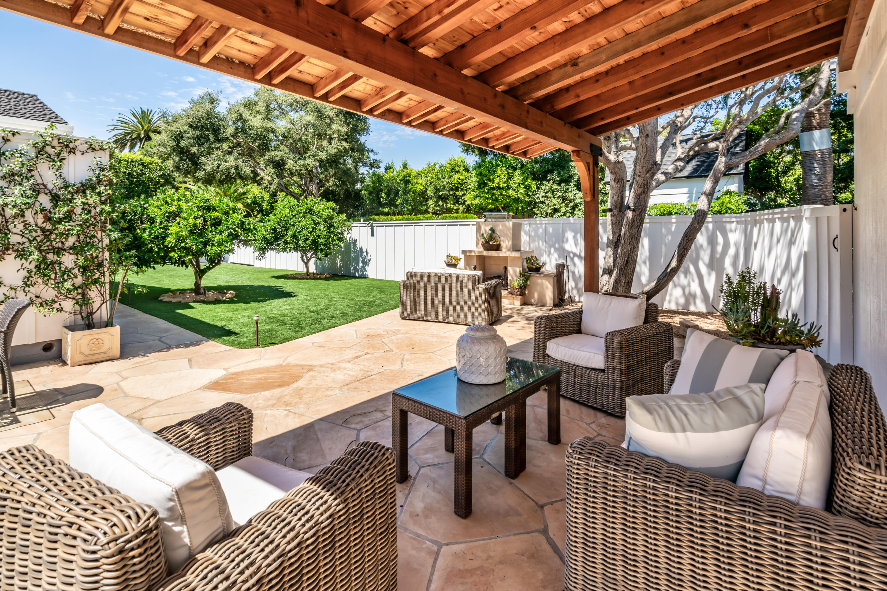1180 High Road Montecito, CA 93108 - Photo 18 of 39 a view of a patio with a table and chairs under an umbrella