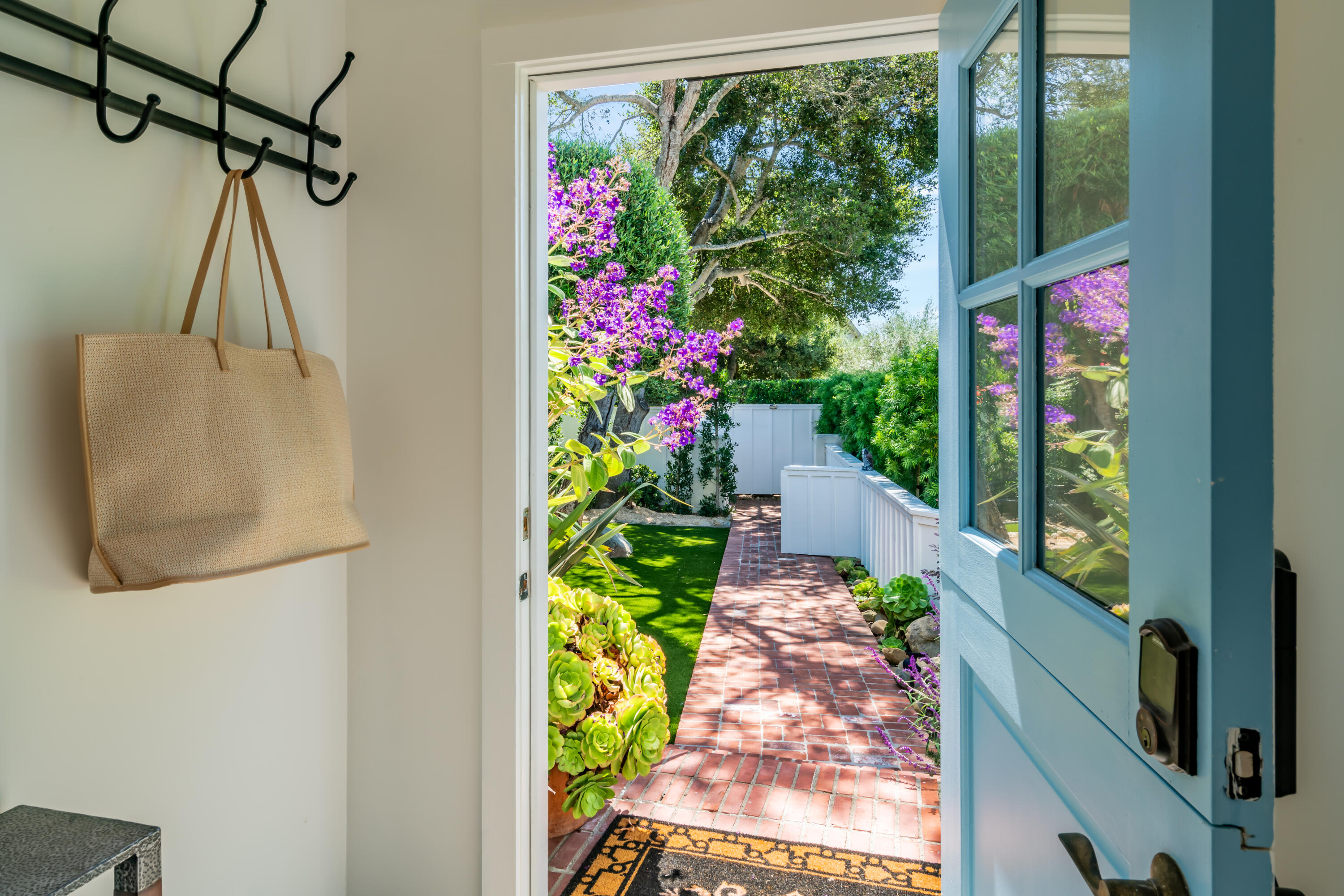1180 High Road Montecito, CA 93108 - Photo 23 of 39 a front view of a house with a yard and a garden