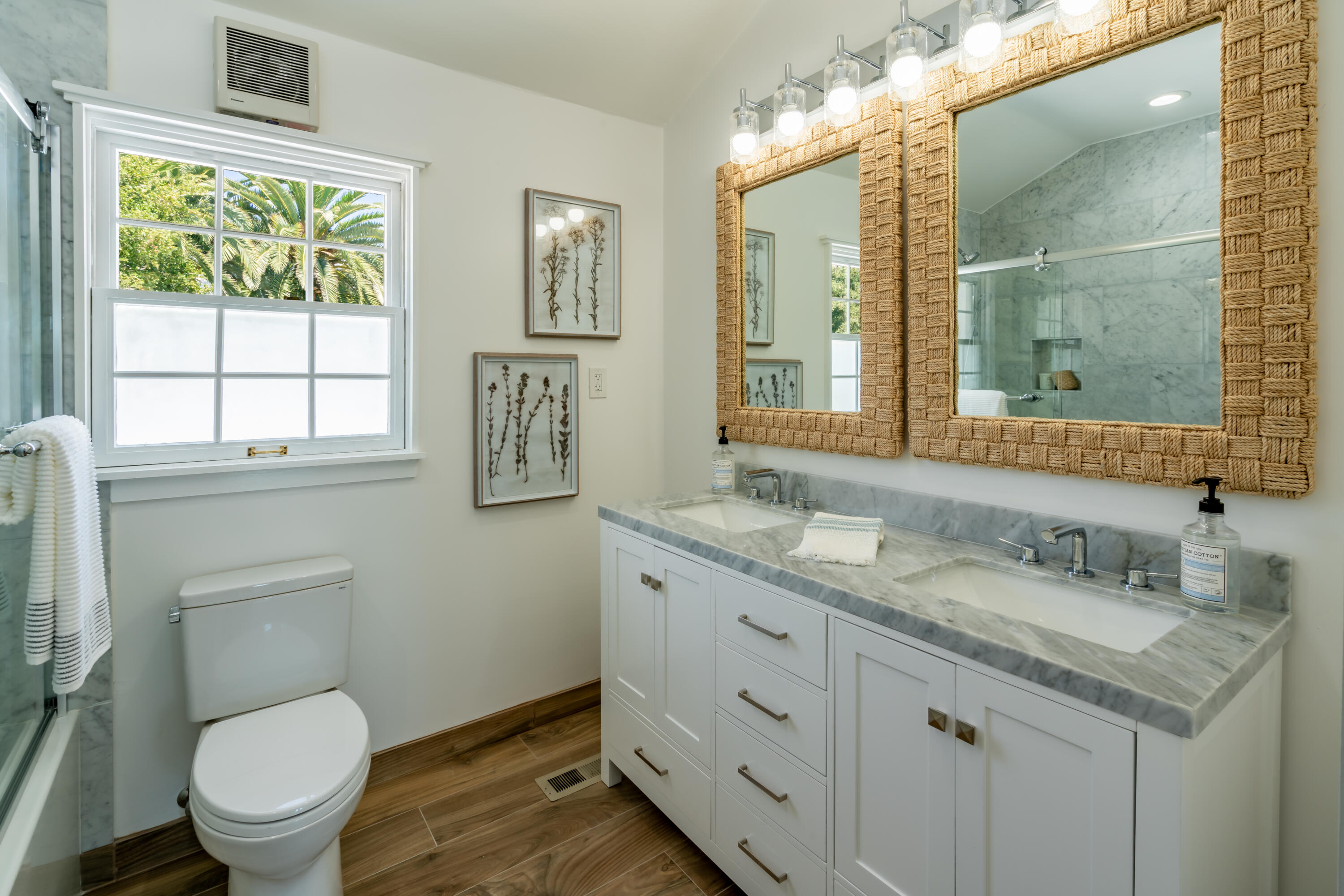 1180 High Road Montecito, CA 93108 - Photo 32 of 39 a bathroom with a granite countertop toilet a sink a mirror and a window