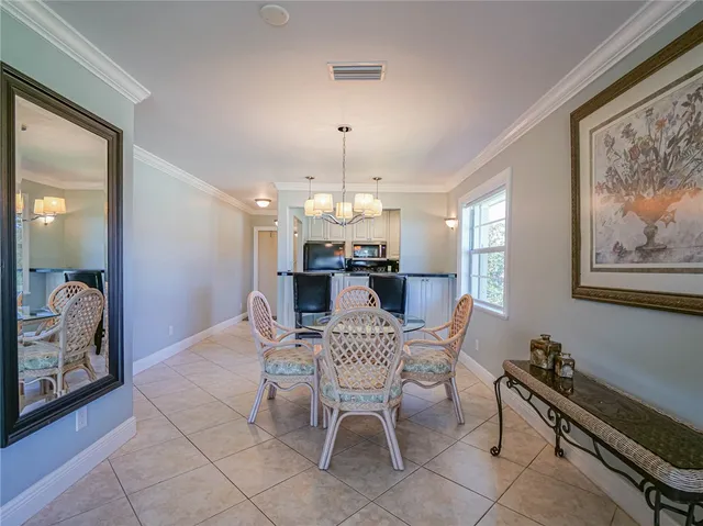 a view of a dining room with furniture and chandelier
