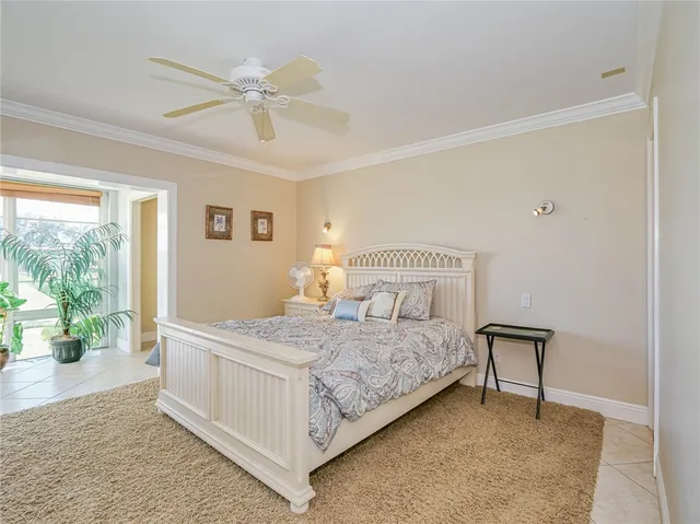 a bedroom with a bed and large windows
