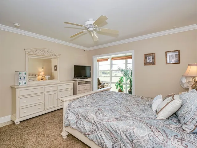 a bedroom with a large bed and a flat screen tv