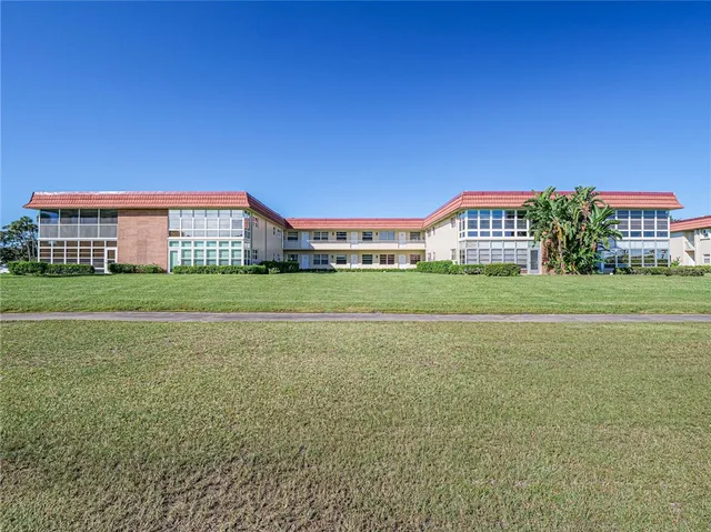 a front view of a building with a garden