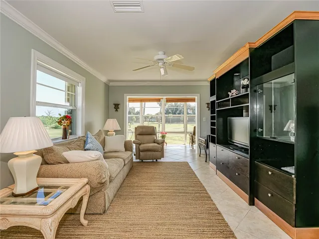 a living room with furniture fireplace and a large window