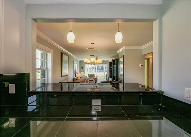 a living room with kitchen island granite countertop furniture and a fireplace