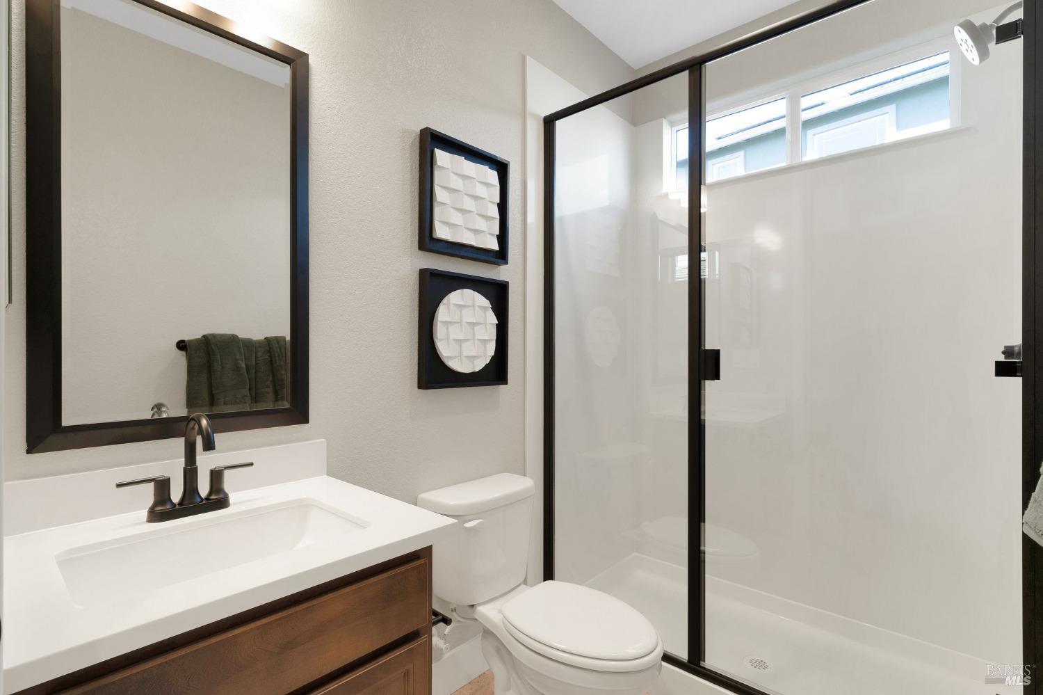 736 Temescal Street Antioch, CA 94561 - Photo 35 of 39 a bathroom with a toilet a sink and a mirror
