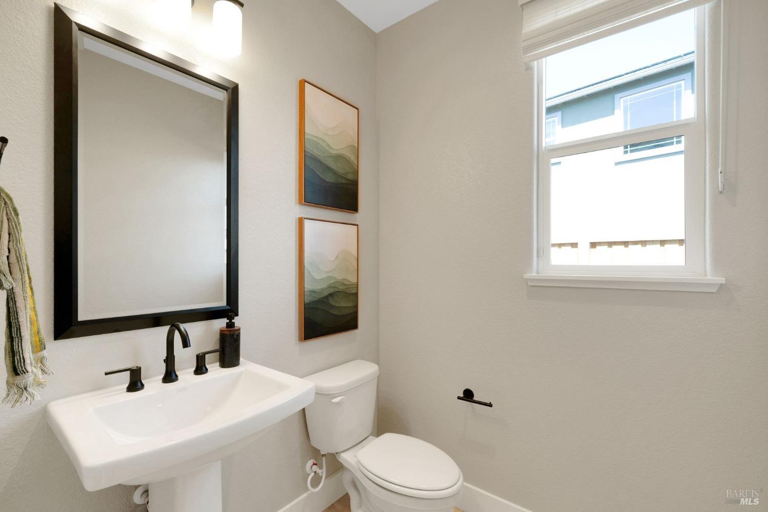 736 Temescal Street Antioch, CA 94561 - Photo 36 of 39 a bathroom with a toilet a sink and a mirror