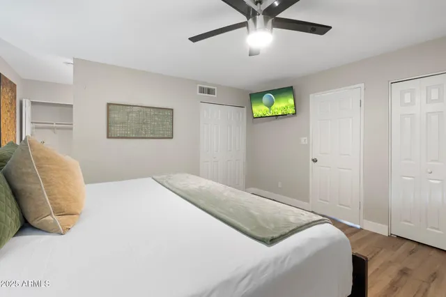 a bedroom with a bed and a chandelier