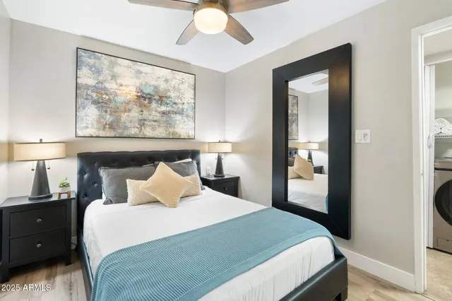 a bedroom with a bed and a large window