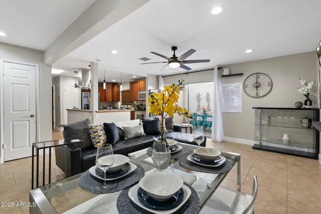 a living room with furniture a clock and a table