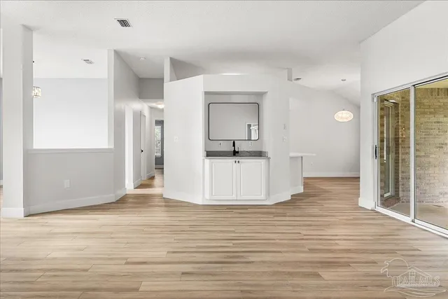 a view of a room with wooden floor and windows