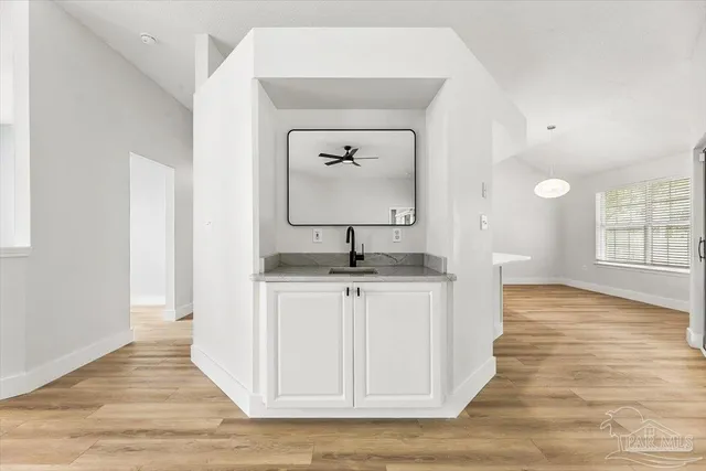 a kitchen with a refrigerator a sink and a stove top oven