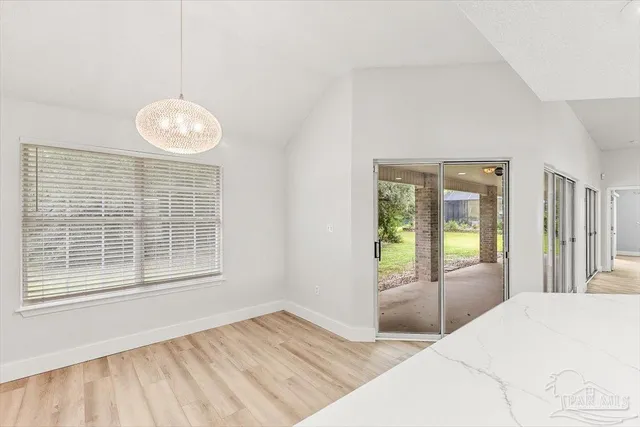 a kitchen with kitchen island white cabinets and refrigerator