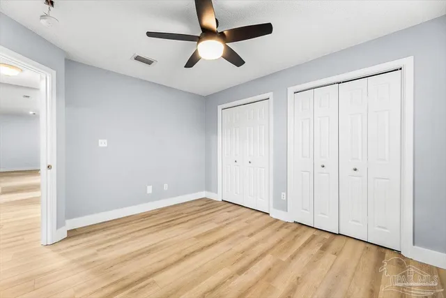 a bathroom with a granite countertop toilet a sink and a mirror