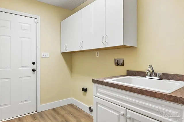 a view of a house with a big yard and potted plants