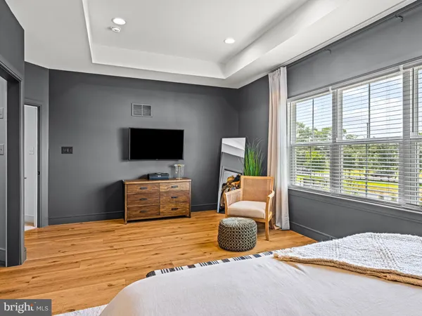 a bedroom with furniture and flat screen tv