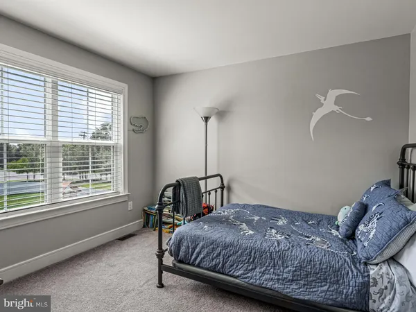 a bedroom with a bed window and a table