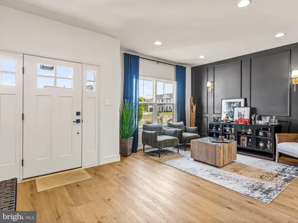 a living room with furniture window and wooden floor