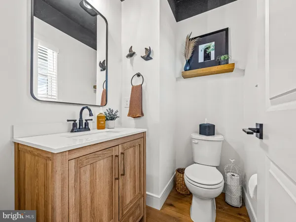 a bathroom with a toilet a sink and mirror