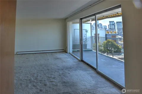 a bathroom with a granite countertop shower sink vanity and toilet