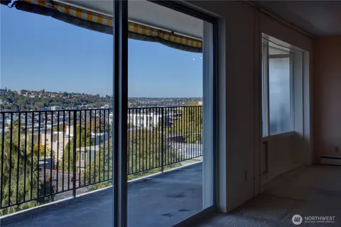 a view of a porch with a floor to ceiling window and wooden floor