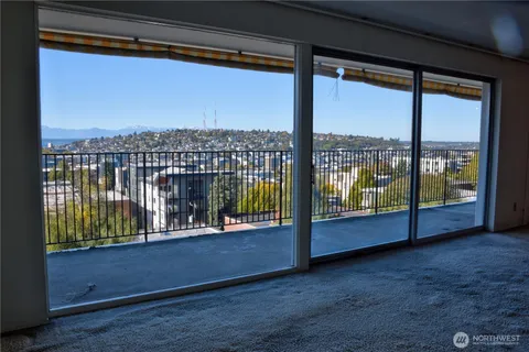 a view of workspace with a floor to ceiling window wooden fence