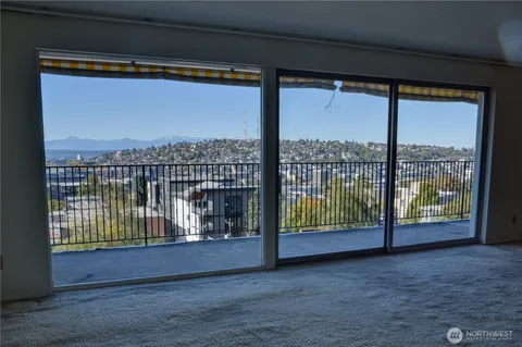 a kitchen with granite countertop white cabinets and sink
