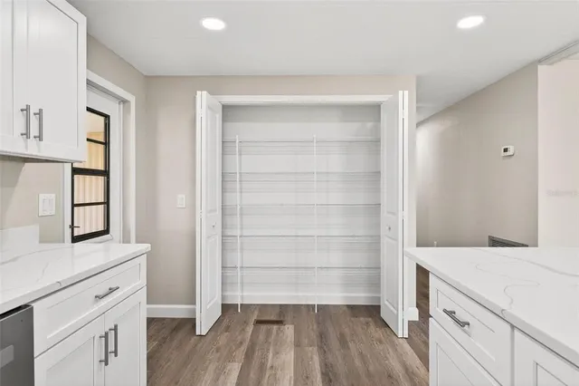 a kitchen with a cabinets and wooden floor