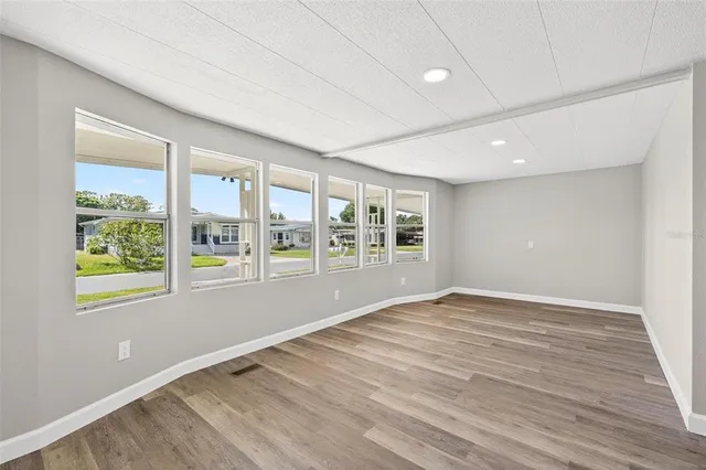 a view of kitchen and hall with wooden floor