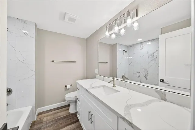a spacious bathroom with a double vanity sink a mirror and a shower