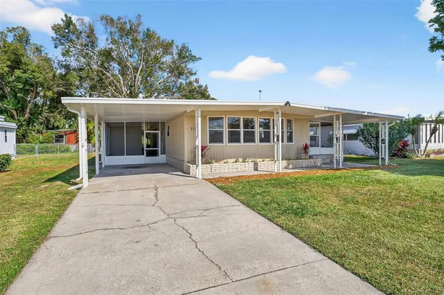 a view of a house with backyard and a tree