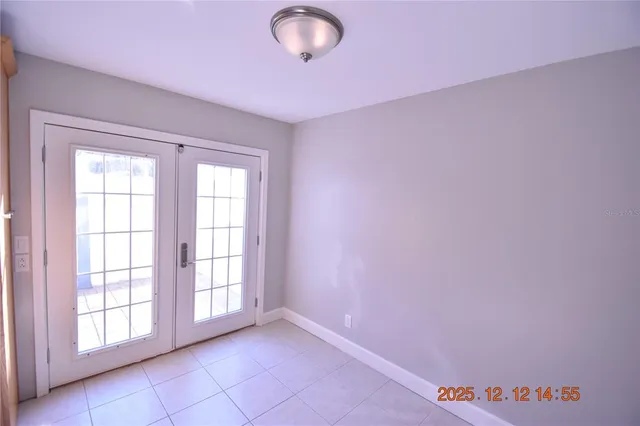 a large kitchen with a large window and stainless steel appliances