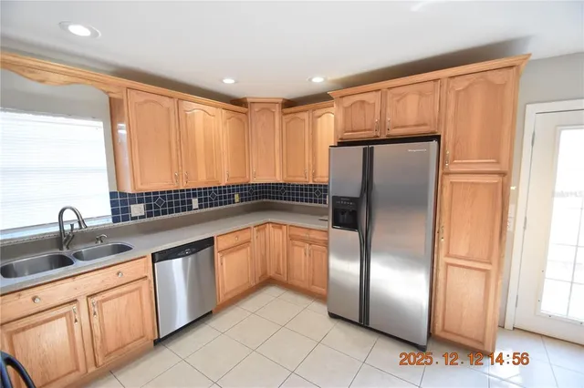 a kitchen with stainless steel appliances a stove sink microwave and cabinets