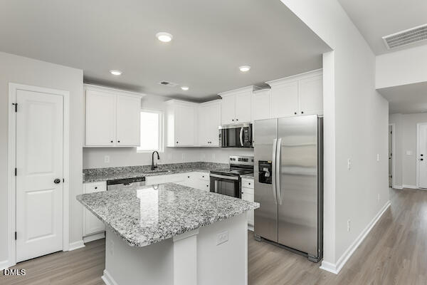 64 Rider Street Broadway, NC 27505 - Photo 2 of 11 a kitchen with stainless steel appliances granite countertop a sink refrigerator and cabinets