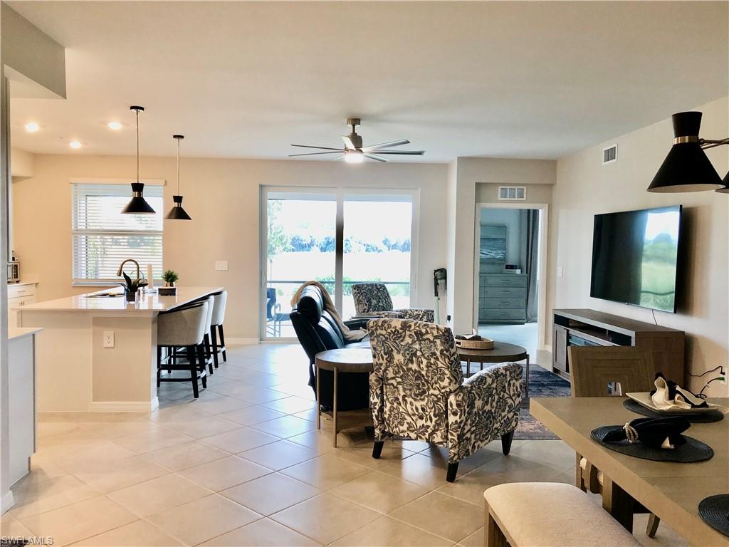43253 Water Bird Way, Unit 5811 Babcock Ranch, FL 33982 - Photo 3 of 21 a living room with furniture and a flat screen tv