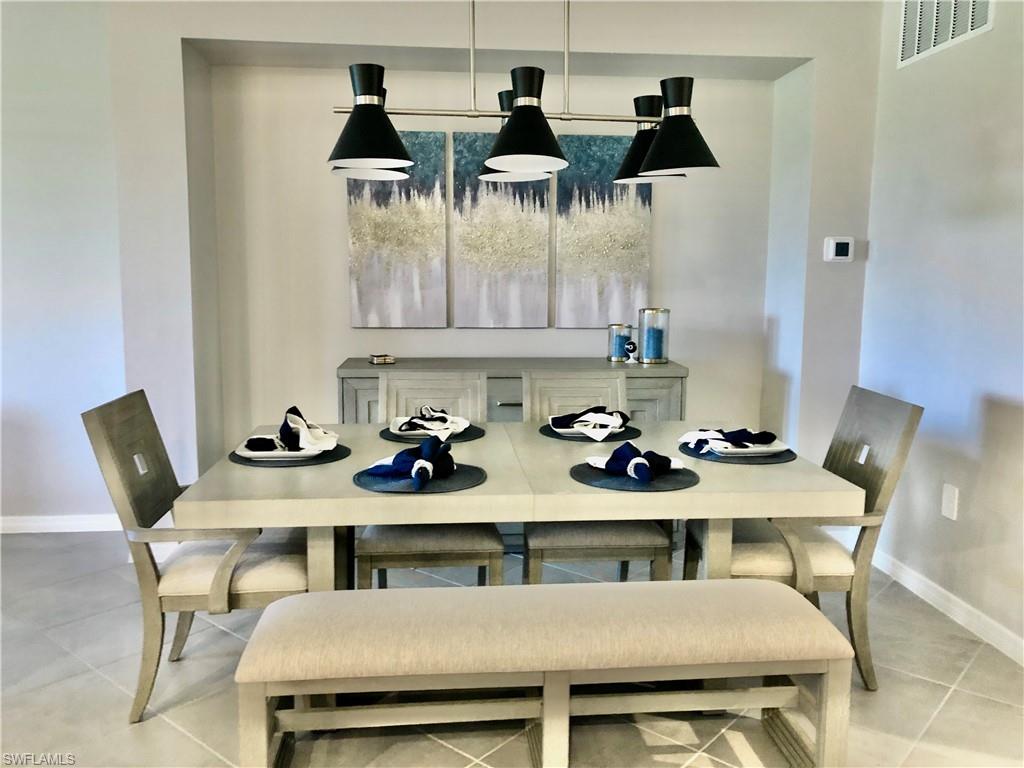43253 Water Bird Way, Unit 5811 Babcock Ranch, FL 33982 - Photo 6 of 21 a view of a dining room with furniture and wooden floor