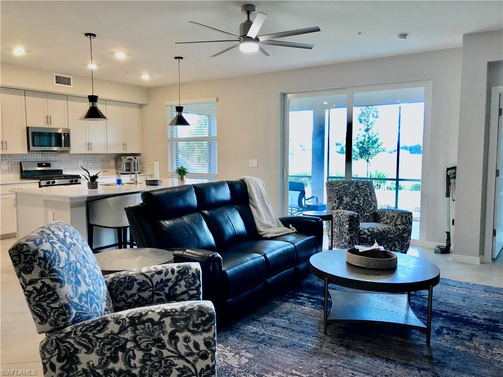 43253 Water Bird Way, Unit 5811 Babcock Ranch, FL 33982 - Photo 8 of 21 a living room with furniture kitchen view and a large window