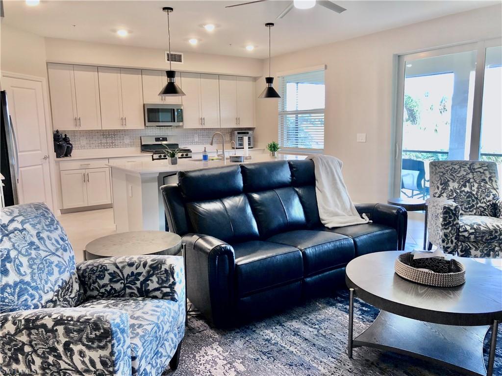 43253 Water Bird Way, Unit 5811 Babcock Ranch, FL 33982 - Photo 9 of 21 a living room with furniture and a view of kitchen