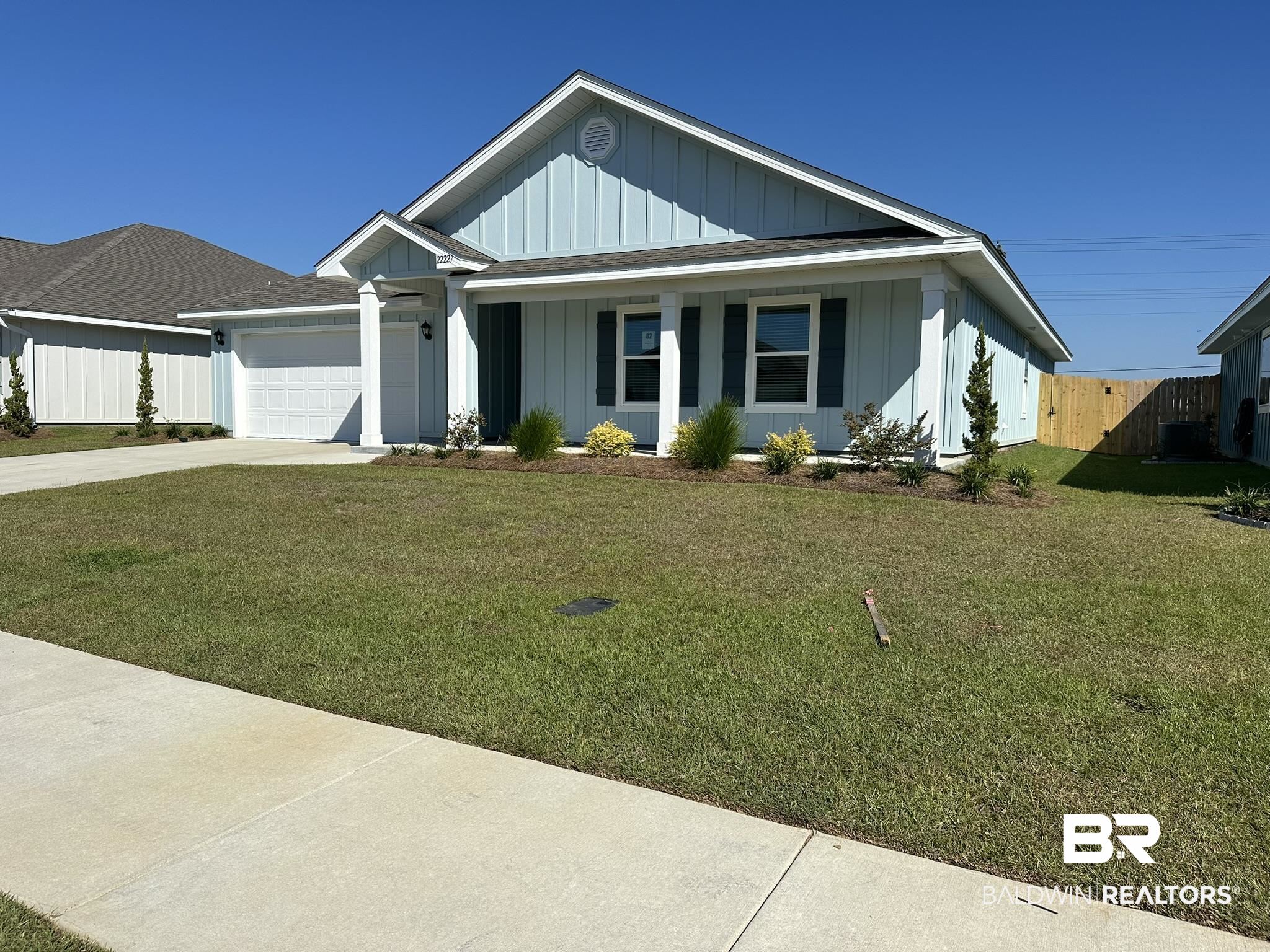 22227 Aleutian Avenue Foley, AL 36535 - Photo 2 of 64 View of front facade featuring a garage and a front yard